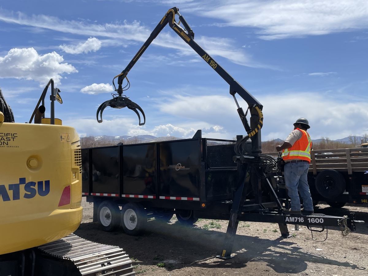 Field crew member operating telehandler at Washoe Wood Yard. Photo by Scott Burdette, USFS.